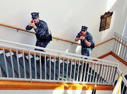 Master-at-Arms 2nd Classes Matthew Latham (left), of