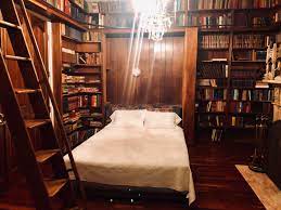 Cozy Library Bedroom Cozyplaces This room, at its skeleton, is cold with its exposed brick walls, black window frames and white wooden beams. cozy library bedroom cozyplaces