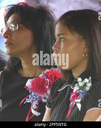 Dr. Barbara Porchia, left, mother of Army Spc. Jonathan Cheatham, and his  sister Portia Cheatham, sit at the graveside funeral service for Cheatham  Sunday, Aug. 3, 2003, at Memorial Park Cemetery in