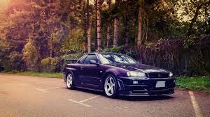 Two white cars, triple screen, nissan gtr r34, toyota supra, mode of transportation. 93 Nissan Skyline Gt R R34 Wallpapers On Wallpapersafari
