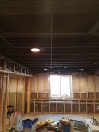 Exposed basement ceiling in black and gray. How To Paint Basement Ceiling With Insulation Arxiusarquitectura