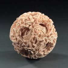 It can be classified as a antique chinese elephant ivory carving dragon puzzle ball with nine levels on puzzle ball plinth, china. A Finely Carved Twenty Seven Sphere Ivory Puzzle Ball Zhuanxinqiu