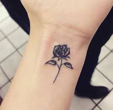 Then this design could be for you. Small Cute Black Rose Tattoo On Wrist For Girls