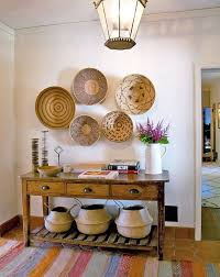 A Colorful Striped Kilim Rug Welcomes Into The Home Where Belly Baskets And Woven Bins Hung On The Wall Hint At The Natural Materi Decor Home Decor Room Decor