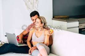 Case of young couples at solusi university. Young Couple At Home Work With Computer Online And Do Stock Photo Crushpixel