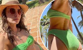 Cara Delevingne displays her incredible bikini body and pert posterior in  strapless green two-piece | Daily Mail Online