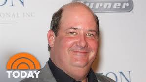Actor Brian Baumgartner serves sausage to residents in Scranton, PA