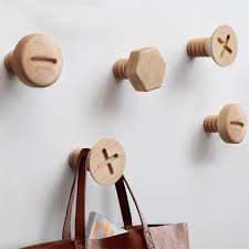 These Clever Wall Hooks Look Like Gigantic Screw Heads In 2020 Home Decor Hooks Wooden Hangers Wall Mounted Hooks