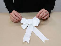 Take the end of the ribbon, about 1″, bunch it together between your thumb and forefinger and twist. 4 Easy Ways To Make A Bow Instructional Video