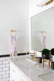 Calacatta gold polished marble calacatta gold polished marble tile collection offers a variety of options from the classic wall to floor tiles to the beautiful crafted mosaics and mouldings. White And Gold Bathroom With Black And White Tiles Transitional Bathroom
