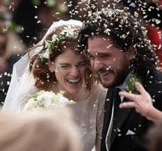 .sleeve stunning white lace wedding dress with floral appliques, a white flower crown and cathedral veil and carried a bouquet of white roses. Game Of Thrones Stars Kit Harington And Rose Leslie Emerge Showered In Confetti After Tying Knot In Stunning Aberdeenshire Castle Wedding