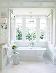 Freestanding baths have long been prized as the ultimate romantic statement: Mini Paris Flea Market Chandelier Over Roll Top Bathtub Transitional Bathroom