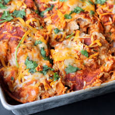 The enchiladas are baked on a layer of sour cream and topped with shredded cheese. Layered Bbq Chicken Sweet Potato Enchilada Casserole Ambitious Kitchen