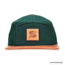 I try to steer clients to the more hip (and vastly easier to build) lower corner option and keep it on one panel but some designs just don't work that way. 5 Panel Caps