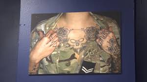 The large crucifix on his back with unknown initials is a personal sign of faith or talisman (ua 486.02). Tattoo Tradition Exploring The Stories Behind Army Ink