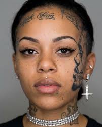 A woman has gone viral after unveiling a full portrait tattoo of her  incarcerated boyfriend across her face, instantly setting off a fierce  debate online. The ink takes up almost half her