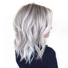 We love these silver highlights underneath the white highlights near the roots. Picture Of Medium Length Silver Blonde Hair With Waves For A Refined Look