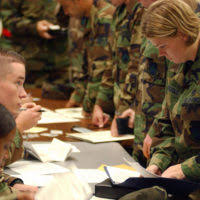 US Air Force (USAF) STAFF Sergeant (SSGT) Enoch Daniels, with the 6th  Medical Group (MG), gives a flu vaccination using a biojector to STAFF  Sergeant (SSGT) Monica Figueroa, from the 6th Comptroller