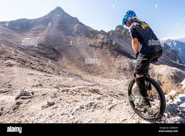 The well-known alpine unicyclist Michael Rung in the Karwendel mountains at  over 2300 m height with his unicycle Stock Photo