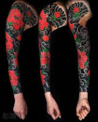 This tattoo includes a black inked skull face that fits on your arm and black outlined roses with red ink inside. I Want This Or A Variation Of This Asap Japanese Tattoo Japanese Flower Tattoo Traditional Japanese Tattoos