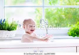Baths designed especially for babies, however, increase your baby's safety, and many fit right into your sink. Baby Taking Bath In Kitchen Sink Child Playing With Foam And Soap Bubbles In Sunny Bathroom
