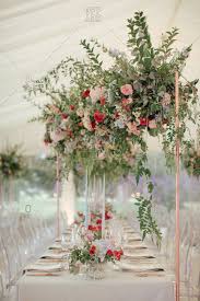 Seating charts act as crowd control, disseminating key information to guests about where their reception home base will be all evening, so you don't have to worry about everyone knowing where to go. Tables With Large Flower Arrangement At A Wedding Reception Stock Photo Offset