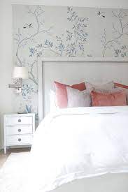 For that pretty pastel feel use a pattern that embraces the room, and gives it a chic feminine approach. Chic Feminine Bedroom Boasts An Accent Wall Clad In Hand Painted Chinoiserie Wallpaper A Feminine Bedroom Bedroom Wallpaper Accent Wall Blue Wallpaper Bedroom
