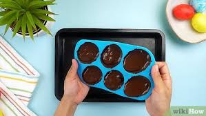 Place the silicone molds on a baking sheet or tray, and pour the melted chocolate into the molds. 3 Ways To Make Easter Eggs Wikihow