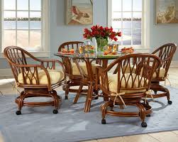 Handsome game table or dining table set including a round glass top rattan base table and four (4) swivel rolling rattan chairs with oatmeal colored upholstered removable seat and ba. Rolling Chairs For Dining Room Dining Chairs Design Ideas Dining Room Furniture Reviews