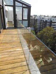When a glazing pane is set in the base mount profile, dedicated chocks are installed to stabilize the pane in the upright position. Balcony Railing Design