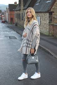 Fashion Blogger Wearing Cape Ripped Jeans And Nike Air Force 1 Lo White Street Style Nike Air Force Outfit Outfits With Leggings Trending Outfits