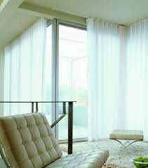 Light chiffon panels in a bright neutral do just the trick when hung from a decorative rod, especially when there are multiple windows that can be covered by a single track. Where Should I Fit A Curtain Track On The Ceiling The Curtain Guru