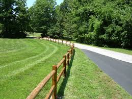 The split rail, or post and rail, fence is essentially a rustic version of a post and board fence style and is similarly a good choice for a decorative accent, for delineating areas, or for marking boundaries without creating a solid visual barrier. Post And Rail Fence Robinson Fence Springfield Mo Wood Fencing Chain Link Fencing Vinyl Fencing Commercial Fencing Ornamental Fencing
