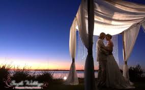 Bride And Groom Under The Lights Of Our Bamboo Canopy For A Waterfront Sunset Wedding At Tamp Waterfront Wedding Venue Beach Wedding Planner Waterfront Wedding