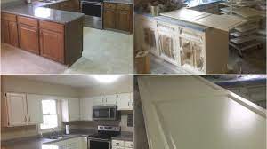Handsome installer in overalls measuring white kitchen cabinet door. What Color Should I Paint My Kitchen Cabinets The Picky Painters Berea Oh