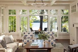 A room for watching the home's overall style skews classic, says williams, with discrete nods to the location such as the tabby fireplace on the porch and the pecky. Lake House With A Classic Coastal Feel Living Room Amazing View Lake House Interior Cottage Living Rooms Cottage Living