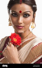 Bengali Frau, die eine Daisy Blume lächelnd Stockfotografie