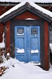 Two story building made of brick and stone with concrete columns painted white. Red House With Blue Doors In Winter Stock Photo Picture And Royalty Free Image Image 17018727