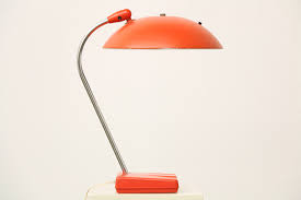 Featuring a soft gold finish over metal construction, this lamp is topped off by a unique cone shade and a convenient rocker switch on the base. Mid Century Modern Desk Lamp Vintage Supply Store