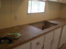Funny thing is the only place without the tile is the countertops, and those are going out to the trash i'm looking into corian tops and a new sink, what i was trying to do is use the formica on the walls like a wainscoating with top chair rail. Tiling Laminate Countertops Part One Queen Of My Trailer