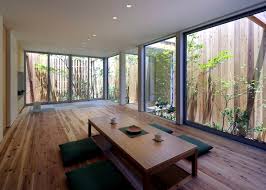 Small trees were planted in the yard. Minimalist Wooden House With A Courtyard In The Middle Of The Big City Interior Design Ideas Ofdesign