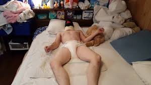 Diaper boy pees his thick diaper and masturbates