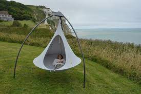 The frame is made from taukkyan wood with electropolished stainless steel components, and the hammock and covering are made from batyline fabric. Cacoon Hammock Tripod Chicago Outdoor Living Cacoon Hammock Hammock Hammock Chair