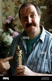 Gordon Kaye after recovering from his near fatal accident with oscar in  hand awarded to him for Actor making the best recovery Stock Photo