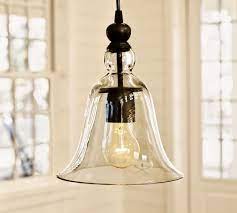 Crafted of iron with a white painted finish. Rustic Glass Outdoor Pendant Pottery Barn