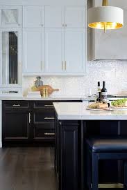 White And Brown Kitchen Features White Upper Cabinets And Espresso Stained Lower Cabinets Adorned With Upper Cabinets Brown Kitchens Espresso Kitchen Cabinets