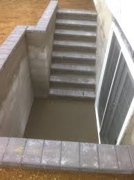 The walkout basement will be entered from the ground level and then slope downward as you go to a below ground level. Outdoor Basement Entrance Concrete Stairwells Long Hill Masonry