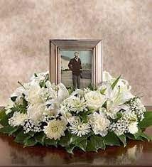 They say that a memorial service is a gift for the living as much as a remembrance for the loved one now gone. Decorating A Memorial Table Ehow Funeral Flower Arrangements Funeral Floral Arrangements Funeral Flowers