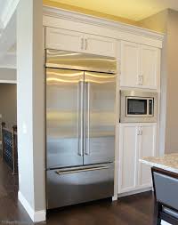 White Painted Kitchen With Koch Cabinetry And A Built In Kitchenaid Refrigerator Design By Vil Beautiful Kitchen Cabinets Built In Refrigerator Kitchen Layout