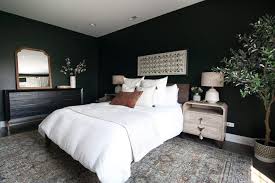 Charming patterns and fresh white accents adorn a solid grey base bedroom. Dark Green Guest Room With Boho Style The Diy Playbook